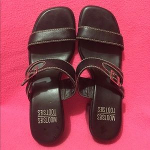 Black leather sandals with silver buckle.